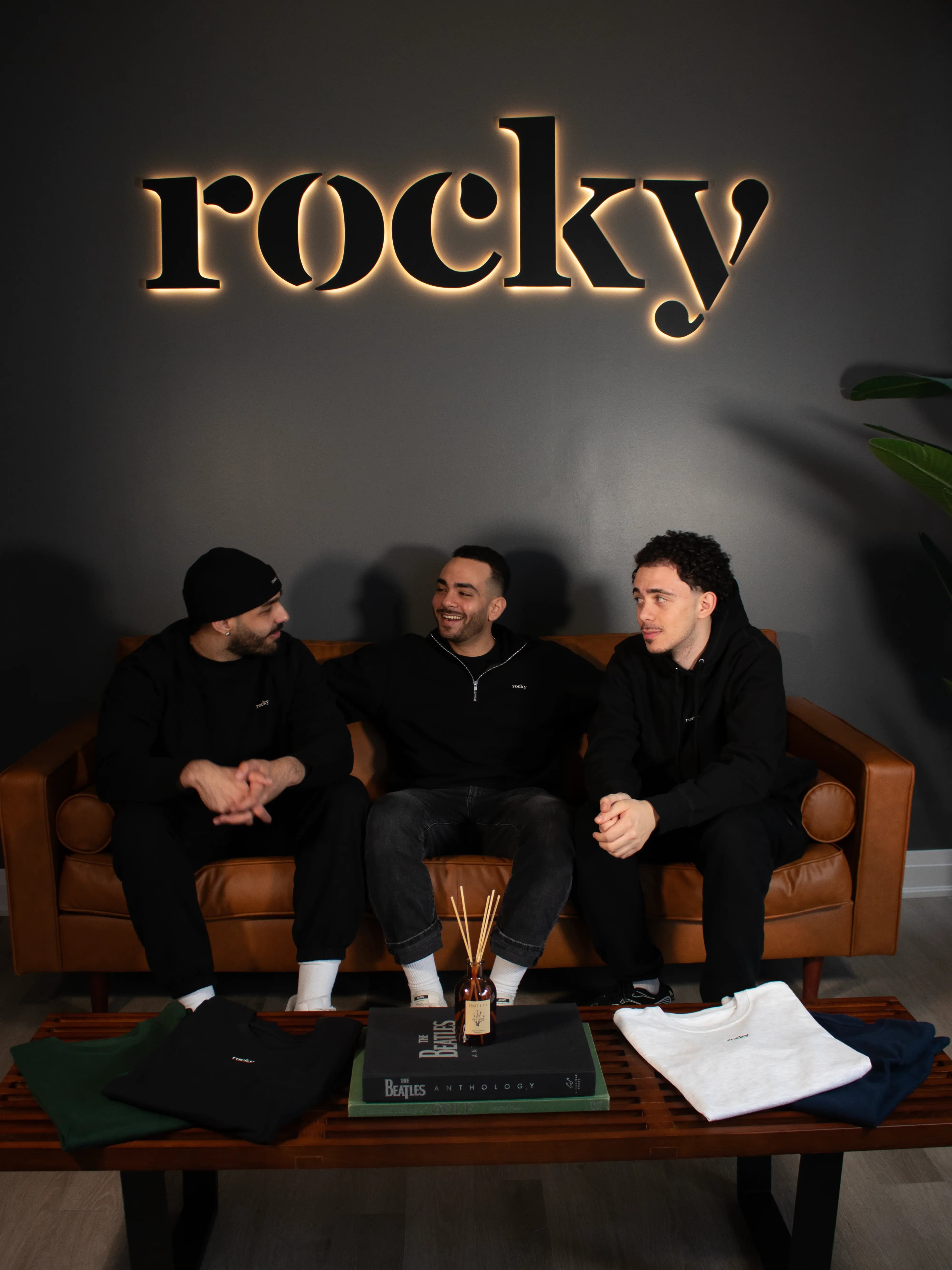Man in black hoodie with plant background