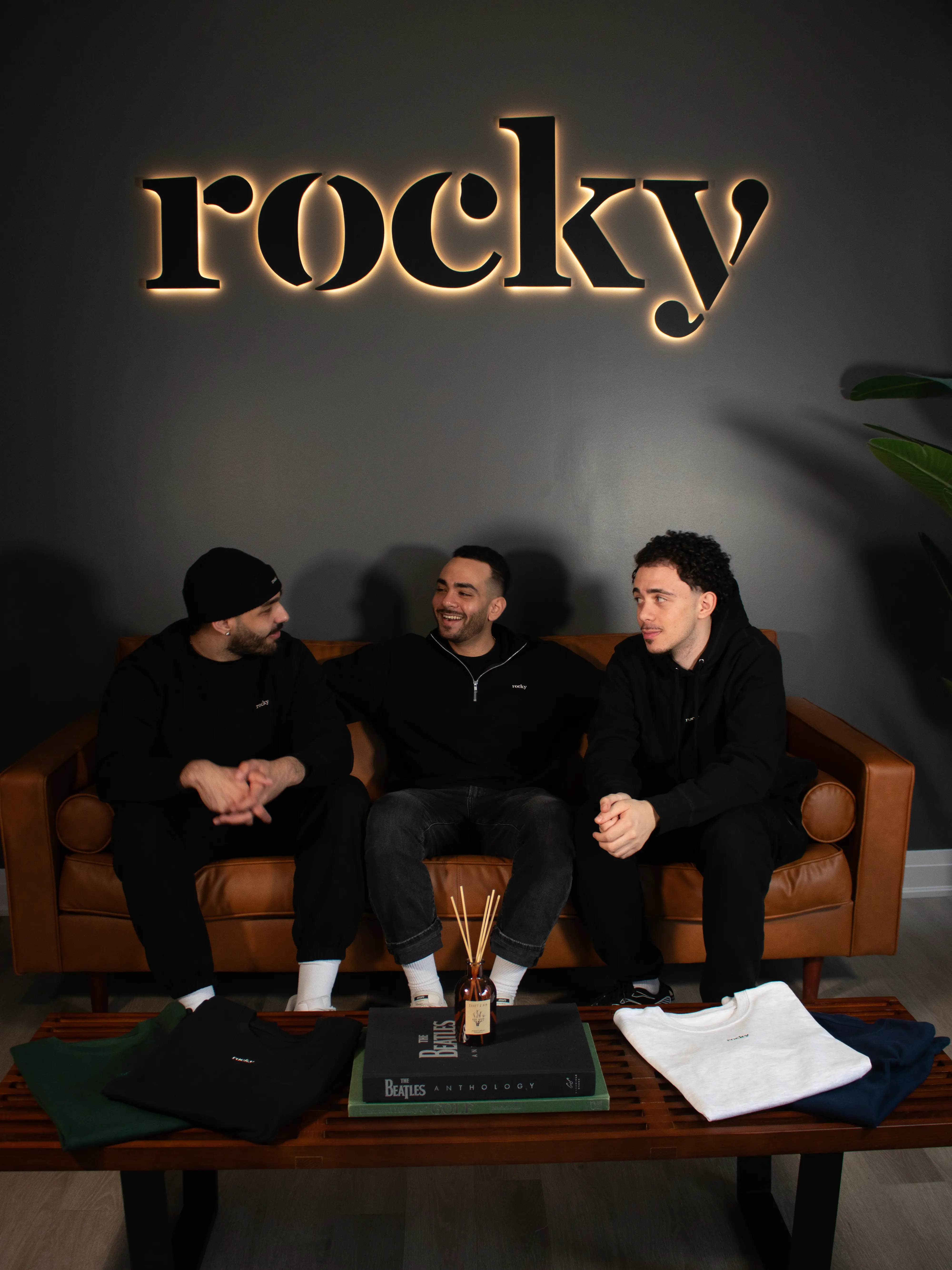 Man in black hoodie with plant background