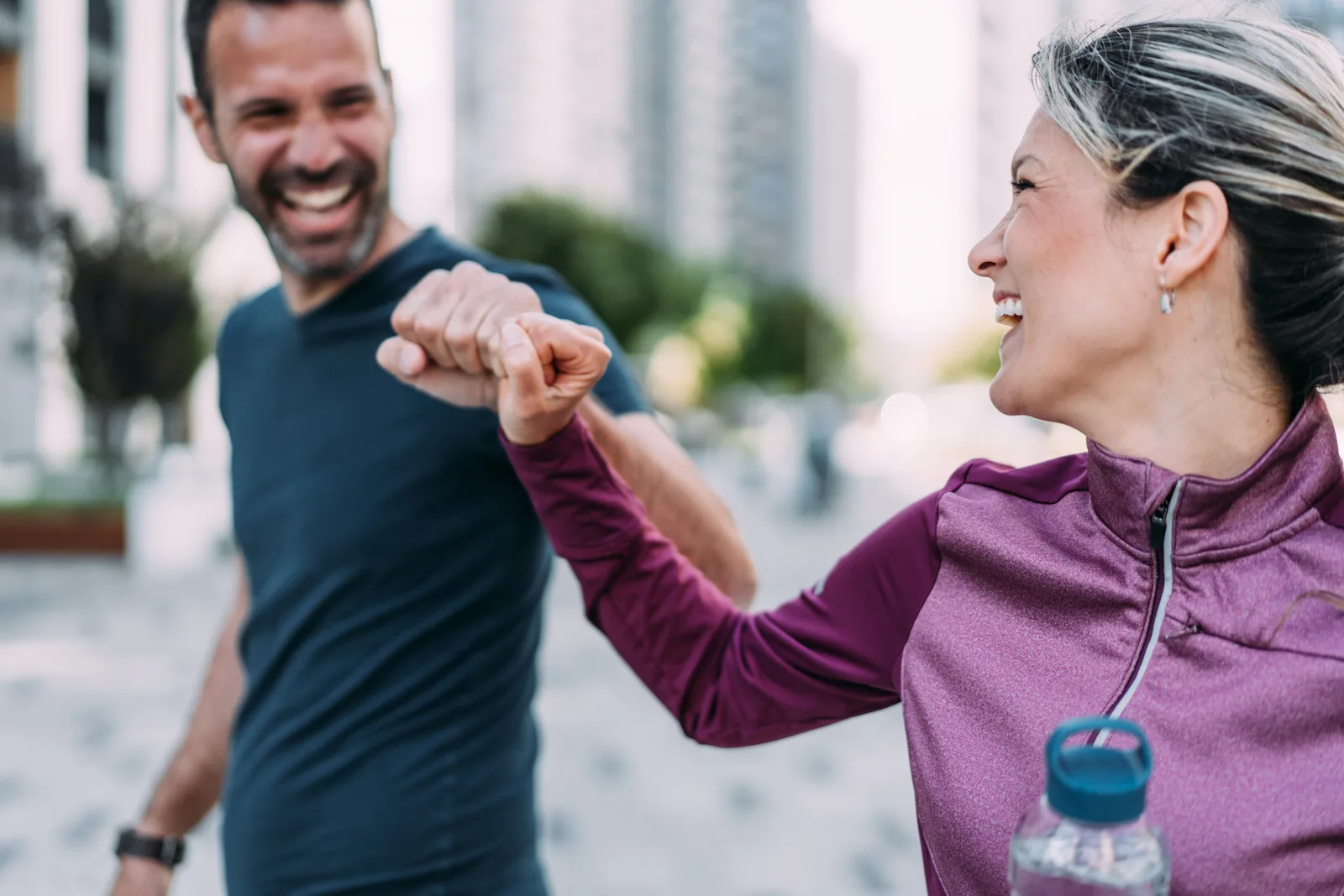 Two people bumping fists after a workout
